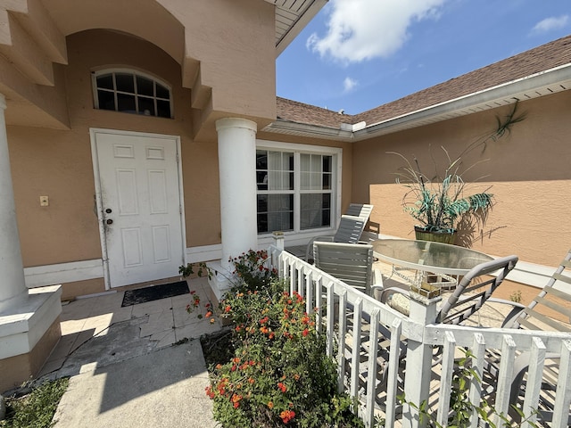 416 SE Calmoso Dr, Port Saint Lucie, FL 34983 - entrance to property with stucco siding and outdoor dining area