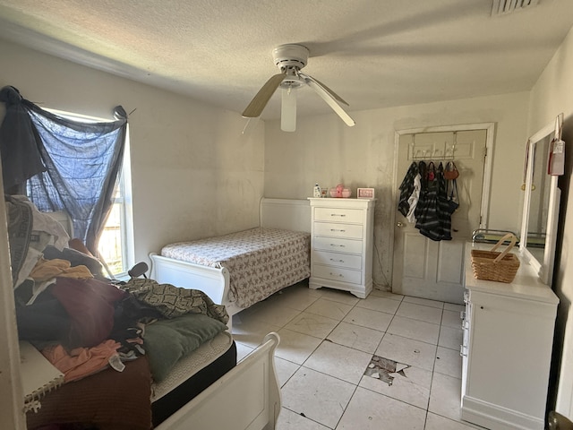 416 SE Calmoso Dr, Port Saint Lucie, FL 34983 - bedroom with a closet, light tile patterned floors, a ceiling fan, and a textured ceiling