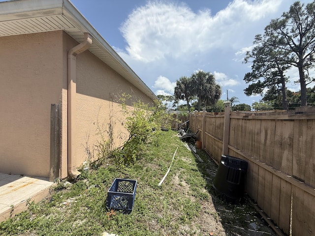 416 SE Calmoso Dr, Port Saint Lucie, FL 34983 - view of yard featuring central air condition unit
