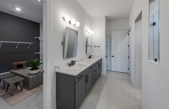10742 Stellar Cir Unit 11, Palm Beach Gardens, FL 33412 - bathroom with double vanity, a spacious closet, and baseboards