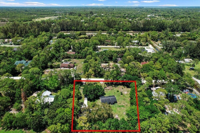 13704 58th Ct N, The Acreage, FL 33411 - aerial overview of property's location featuring a heavily wooded area and property parcel outlined
