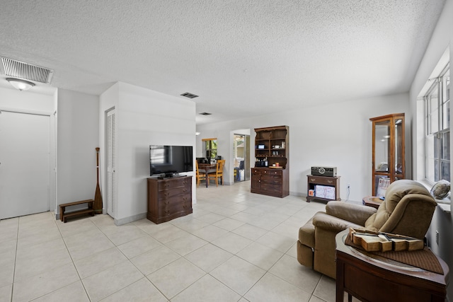 13704 58th Ct N, The Acreage, FL 33411 - living area with light tile patterned floors, a textured ceiling, and baseboards
