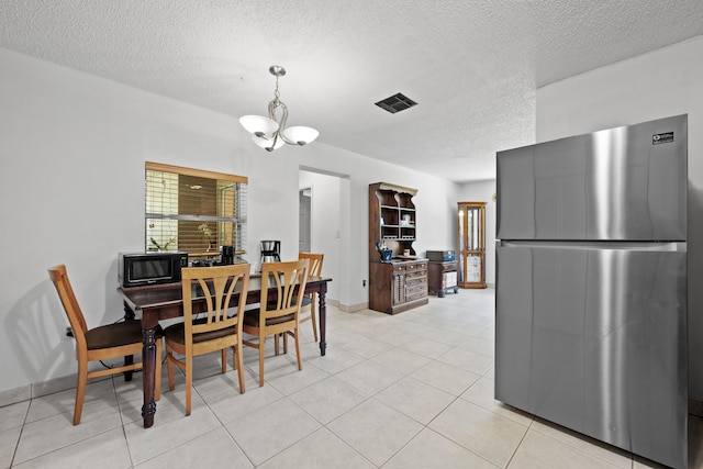 13704 58th Ct N, The Acreage, FL 33411 - dining room featuring a textured ceiling, light tile patterned flooring, and baseboards