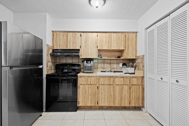 13704 58th Ct N, The Acreage, FL 33411 - kitchen featuring freestanding refrigerator, black range with electric cooktop, range hood, a sink, and light countertops