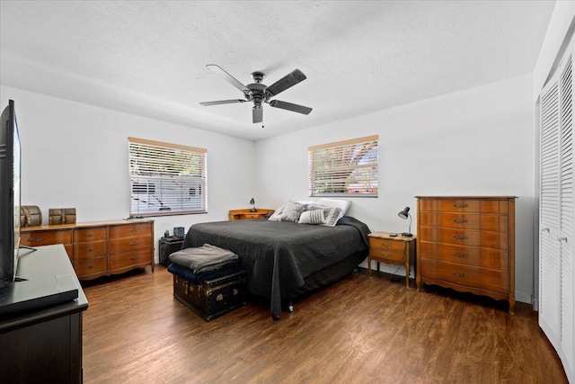 13704 58th Ct N, The Acreage, FL 33411 - bedroom with dark wood finished floors, ceiling fan, a textured ceiling, and a closet