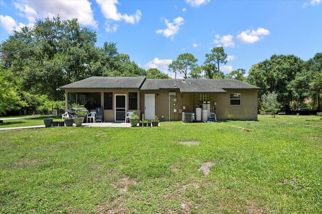 13704 58th Ct N, The Acreage, FL 33411 - rear view of house with cooling unit, a lawn, and stucco siding