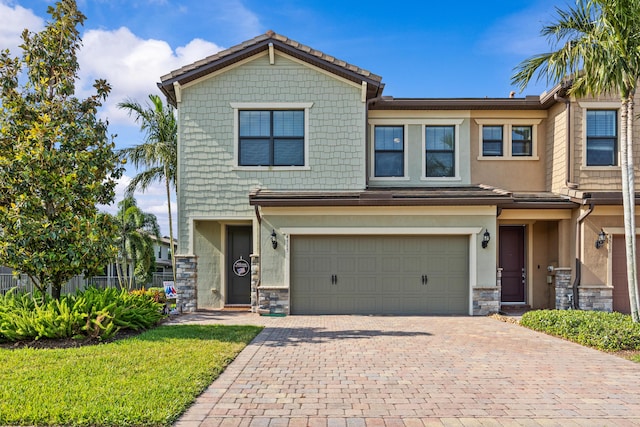 4515 San Fratello Cir, Lake Worth, FL 33467 - view of front of property featuring stone siding, decorative driveway, a garage, stucco siding, and a front lawn