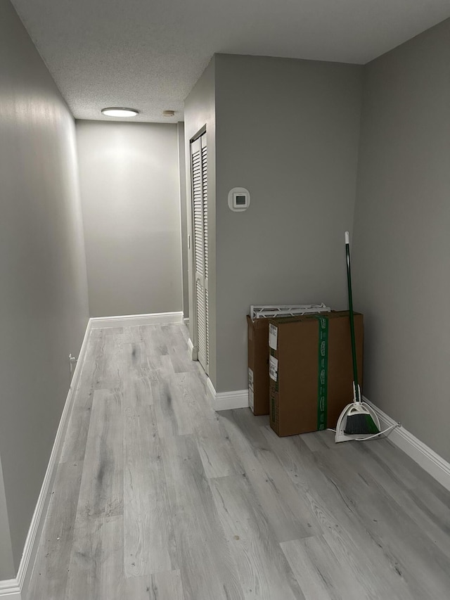 6644 Country Winds Cv, Lake Worth, FL 33463 - hallway with wood finished floors, baseboards, and a textured ceiling