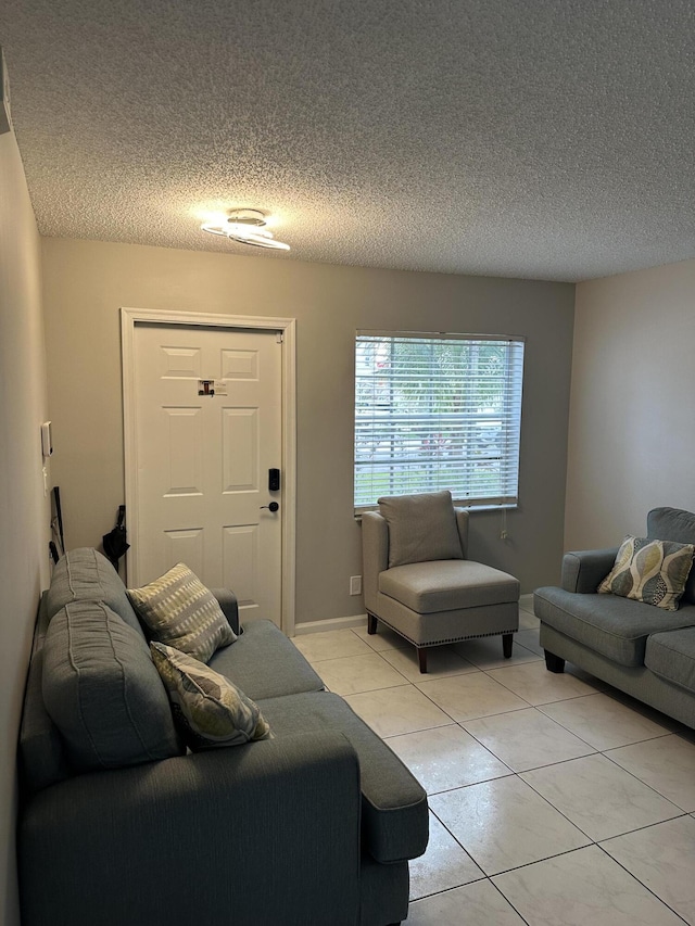 6644 Country Winds Cv, Lake Worth, FL 33463 - living area with a textured ceiling, light tile patterned flooring, and baseboards