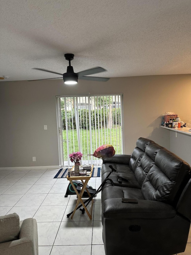 6644 Country Winds Cv, Lake Worth, FL 33463 - living room with ceiling fan, a textured ceiling, light tile patterned floors, and baseboards