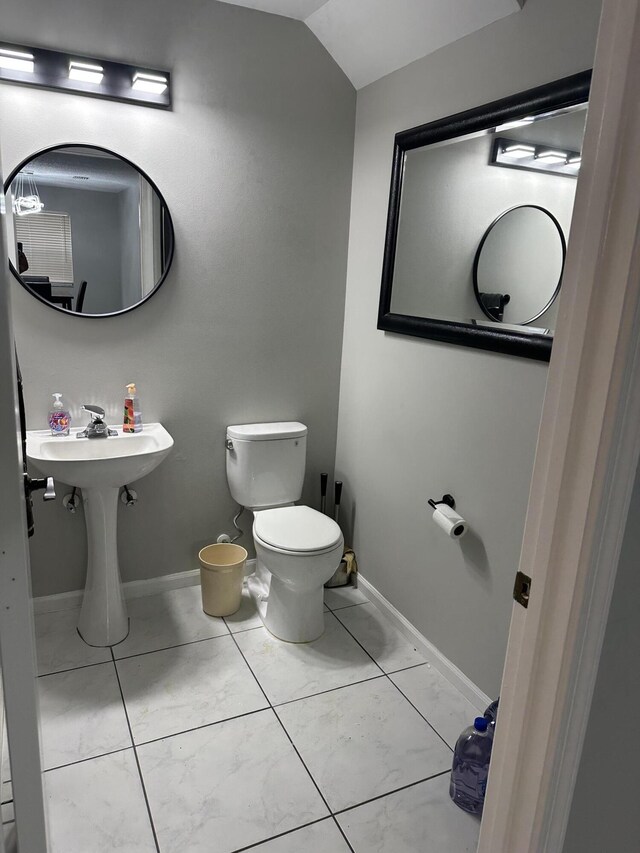 6644 Country Winds Cv, Lake Worth, FL 33463 - bathroom featuring toilet, lofted ceiling, and baseboards