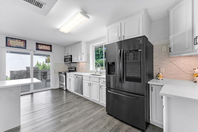 18905 Cloud Lake Cir, Boca Raton, FL 33496 - kitchen with appliances with stainless steel finishes, light countertops, a sink, and tasteful backsplash
