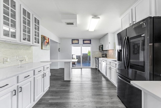 18905 Cloud Lake Cir, Boca Raton, FL 33496 - kitchen with stainless steel appliances, white cabinetry, tasteful backsplash, and glass insert cabinets