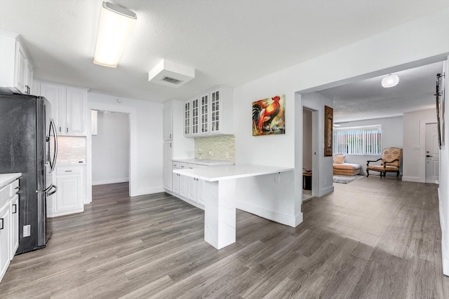 18905 Cloud Lake Cir, Boca Raton, FL 33496 - kitchen with freestanding refrigerator, backsplash, light countertops, glass insert cabinets, and a textured ceiling