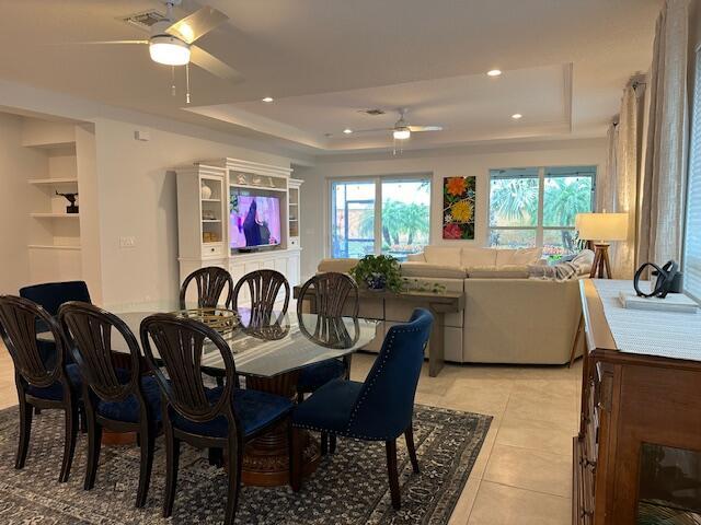9624 SW Royal Poinciana Dr, Port Saint Lucie, FL 34987 - dining space with ceiling fan, a tray ceiling, recessed lighting, and light tile patterned flooring