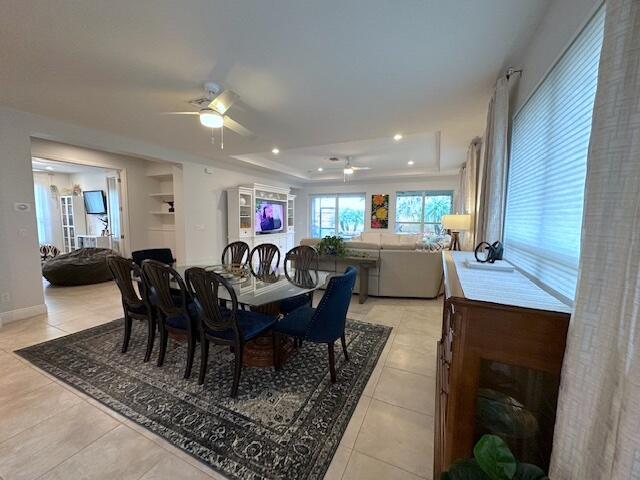 9624 SW Royal Poinciana Dr, Port Saint Lucie, FL 34987 - dining space with ceiling fan, light tile patterned flooring, a raised ceiling, and recessed lighting