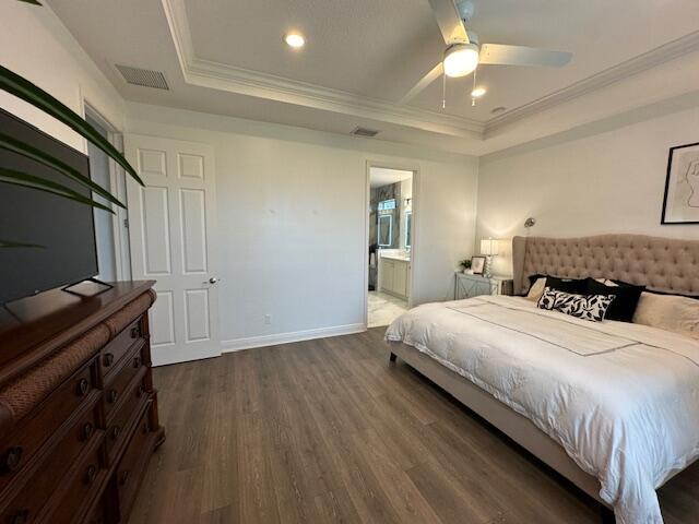 9624 SW Royal Poinciana Dr, Port Saint Lucie, FL 34987 - bedroom with wood finished floors, ornamental molding, baseboards, ensuite bathroom, and recessed lighting