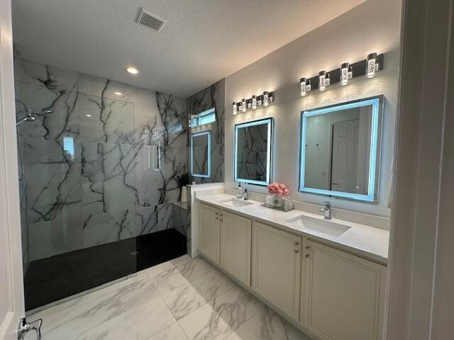 9624 SW Royal Poinciana Dr, Port Saint Lucie, FL 34987 - full bath with marble finish floors, double vanity, a textured ceiling, a marble finish shower, and recessed lighting