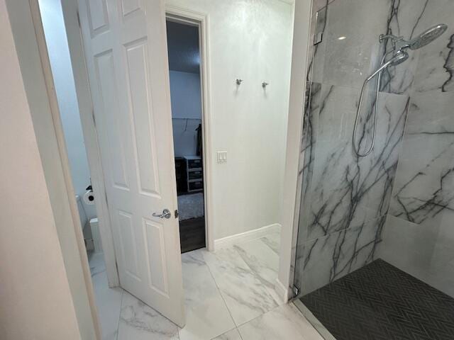 9624 SW Royal Poinciana Dr, Port Saint Lucie, FL 34987 - full bath with marble look tile flooring, a marble finish shower, toilet, and baseboards