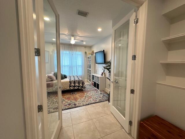 9624 SW Royal Poinciana Dr, Port Saint Lucie, FL 34987 - ensuite bathroom featuring tile patterned floors, a ceiling fan, recessed lighting, and french doors
