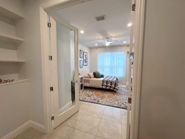 9624 SW Royal Poinciana Dr, Port Saint Lucie, FL 34987 - bedroom with light tile patterned floors, recessed lighting, baseboards, french doors, and ceiling fan