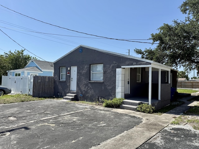 172 W 15th St, Riviera Beach, FL 33404 - view of front of home with stucco siding and entry steps