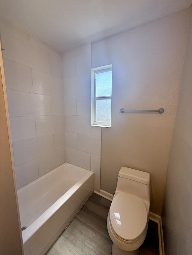172 W 15th St, Riviera Beach, FL 33404 - bathroom with wood finished floors, toilet, and baseboards