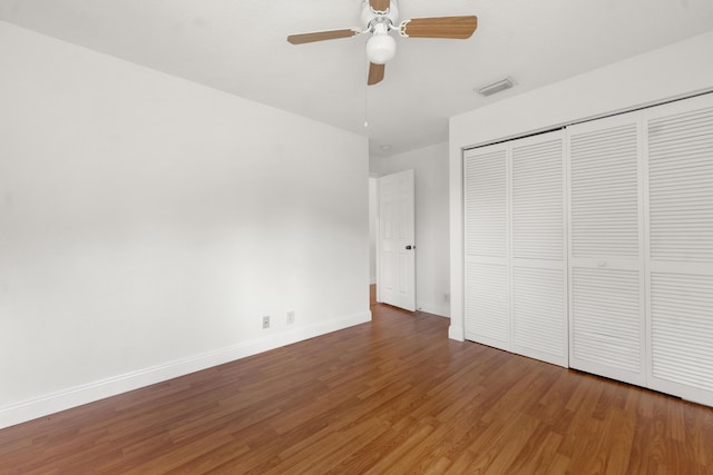 4474 Foxtail Ln, Weston, FL 33331 - unfurnished bedroom featuring wood finished floors, baseboards, a closet, and a ceiling fan