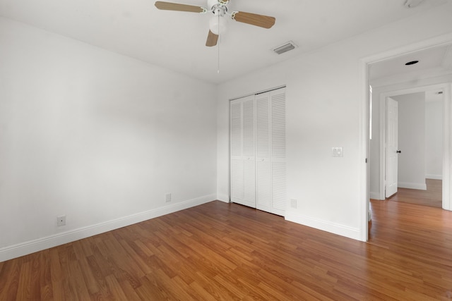 4474 Foxtail Ln, Weston, FL 33331 - unfurnished bedroom featuring wood finished floors, baseboards, a closet, and a ceiling fan
