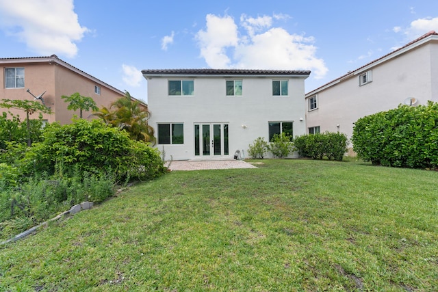 4474 Foxtail Ln, Weston, FL 33331 - back of house with french doors, a yard, stucco siding, and a patio