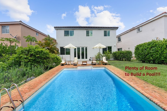 4474 Foxtail Ln, Weston, FL 33331 - rear view of property with an outdoor pool and stucco siding