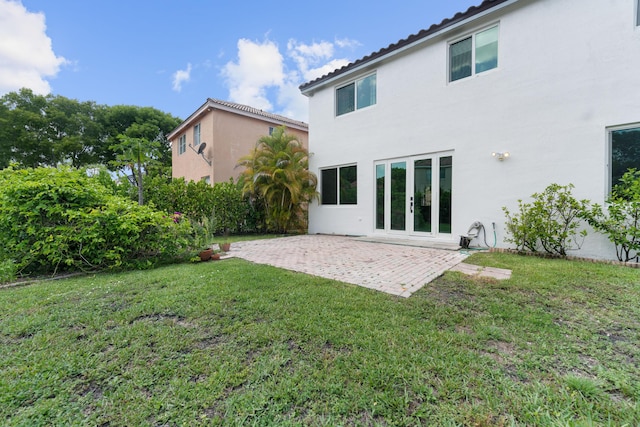 4474 Foxtail Ln, Weston, FL 33331 - back of house with stucco siding, a patio area, and a lawn