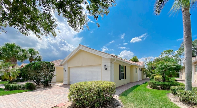 10453 SW Stratton Dr, Port Saint Lucie, FL 34987 - view of front of home featuring an attached garage, stucco siding, and driveway