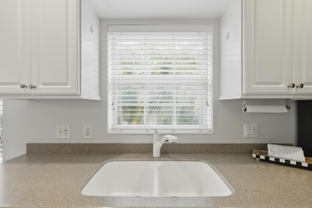 10453 SW Stratton Dr, Port Saint Lucie, FL 34987 - kitchen featuring a sink, white cabinetry, and light countertops