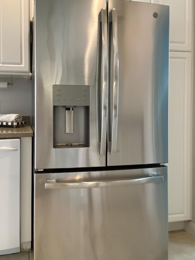 10453 SW Stratton Dr, Port Saint Lucie, FL 34987 - kitchen view of stainless steel fridge with ice dispenser, dishwasher, white cabinetry, and dark countertops