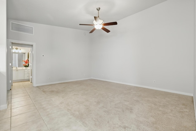 10453 SW Stratton Dr, Port Saint Lucie, FL 34987 - empty room with a ceiling fan, light carpet, baseboards, and light tile patterned floors