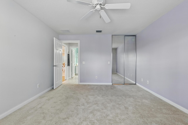 10453 SW Stratton Dr, Port Saint Lucie, FL 34987 - unfurnished bedroom with light carpet, baseboards, and ceiling fan