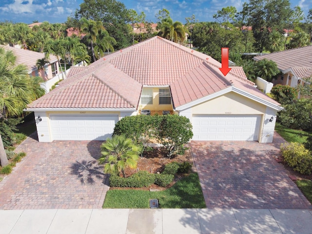 10453 SW Stratton Dr, Port Saint Lucie, FL 34987 - view of front of house with decorative driveway and a tile roof