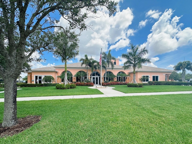 10453 SW Stratton Dr, Port Saint Lucie, FL 34987 - mediterranean / spanish home with a front yard and stucco siding