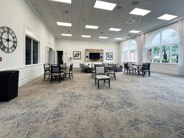 10453 SW Stratton Dr, Port Saint Lucie, FL 34987 - dining room with carpet, a paneled ceiling, and a decorative wall