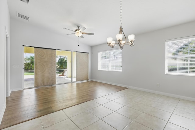 10453 SW Stratton Dr, Port Saint Lucie, FL 34987 - unfurnished room featuring healthy amount of natural light, a ceiling fan, a chandelier, light tile patterned floors, and lofted ceiling