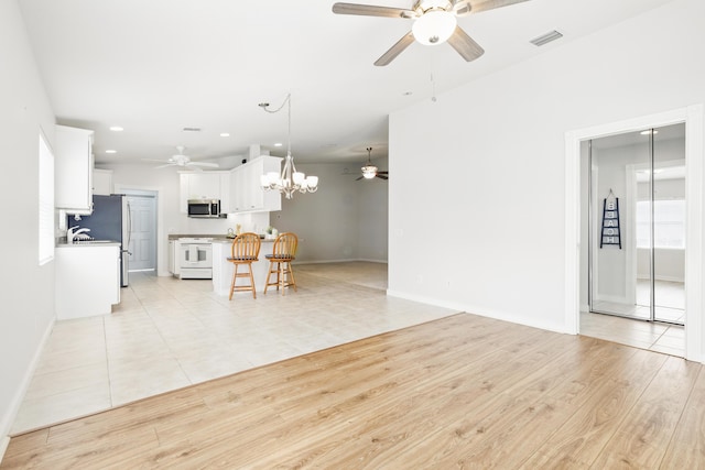 10453 SW Stratton Dr, Port Saint Lucie, FL 34987 - living room with a ceiling fan, a chandelier, baseboards, recessed lighting, and light wood-type flooring