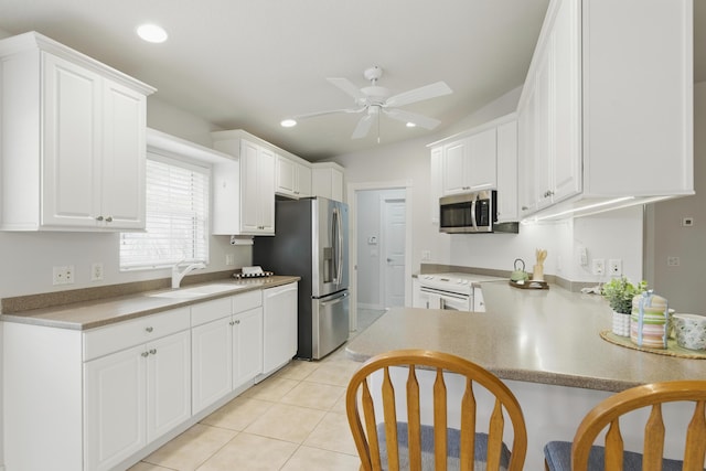 10453 SW Stratton Dr, Port Saint Lucie, FL 34987 - kitchen featuring a sink, appliances with stainless steel finishes, a ceiling fan, recessed lighting, and white cabinetry