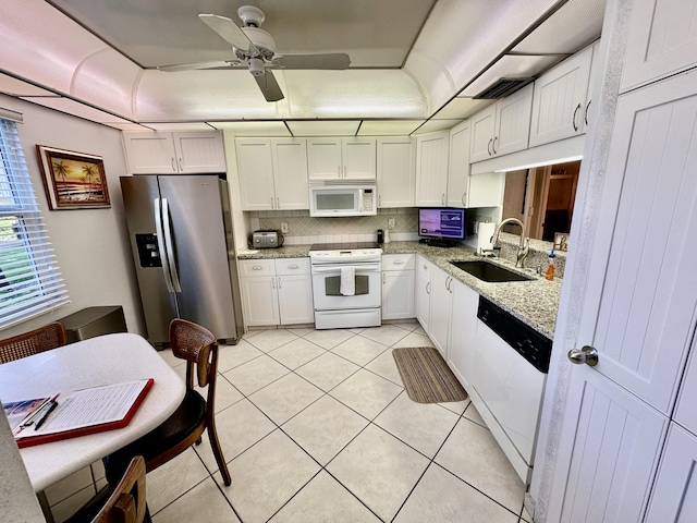3301 Aruba Way Unit A1, Coconut Creek, FL 33066 - kitchen with white appliances, a sink, ceiling fan, light tile patterned floors, and white cabinetry