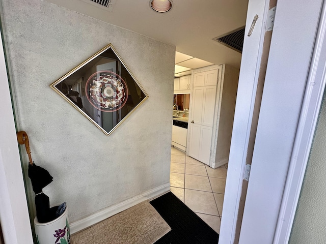 3301 Aruba Way Unit A1, Coconut Creek, FL 33066 - hallway with light tile patterned flooring, a sink, a textured wall, and baseboards