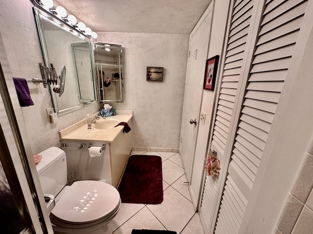 3301 Aruba Way Unit A1, Coconut Creek, FL 33066 - bathroom featuring a closet, a textured wall, tile patterned flooring, toilet, and vanity