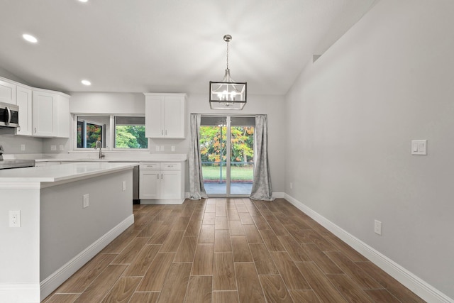 5609 Sunset Blvd, Fort Pierce, FL 34982 - kitchen with range, baseboards, dark wood finished floors, a chandelier, and recessed lighting