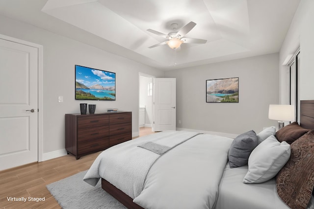 5609 Sunset Blvd, Fort Pierce, FL 34982 - bedroom featuring a raised ceiling, baseboards, light wood-style flooring, and ceiling fan