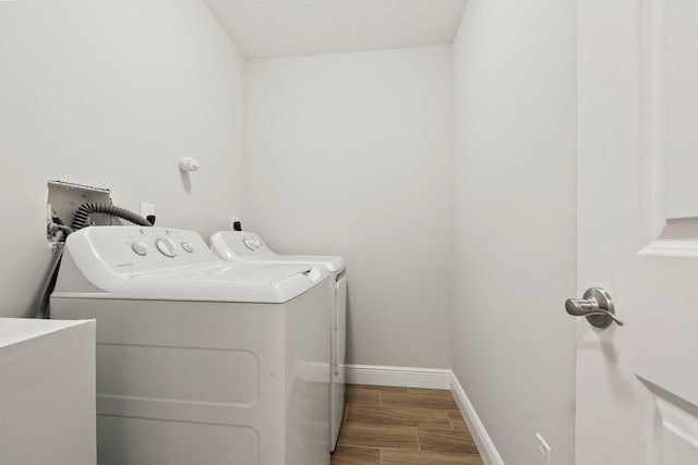 5609 Sunset Blvd, Fort Pierce, FL 34982 - washroom featuring washing machine and dryer, wood finished floors, and baseboards