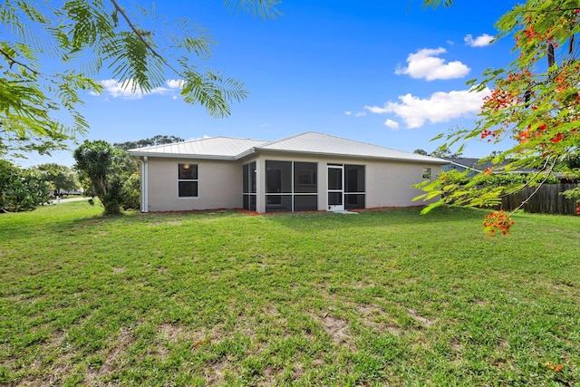 5609 Sunset Blvd, Fort Pierce, FL 34982 - rear view of house featuring a sunroom, metal roof, and stucco siding